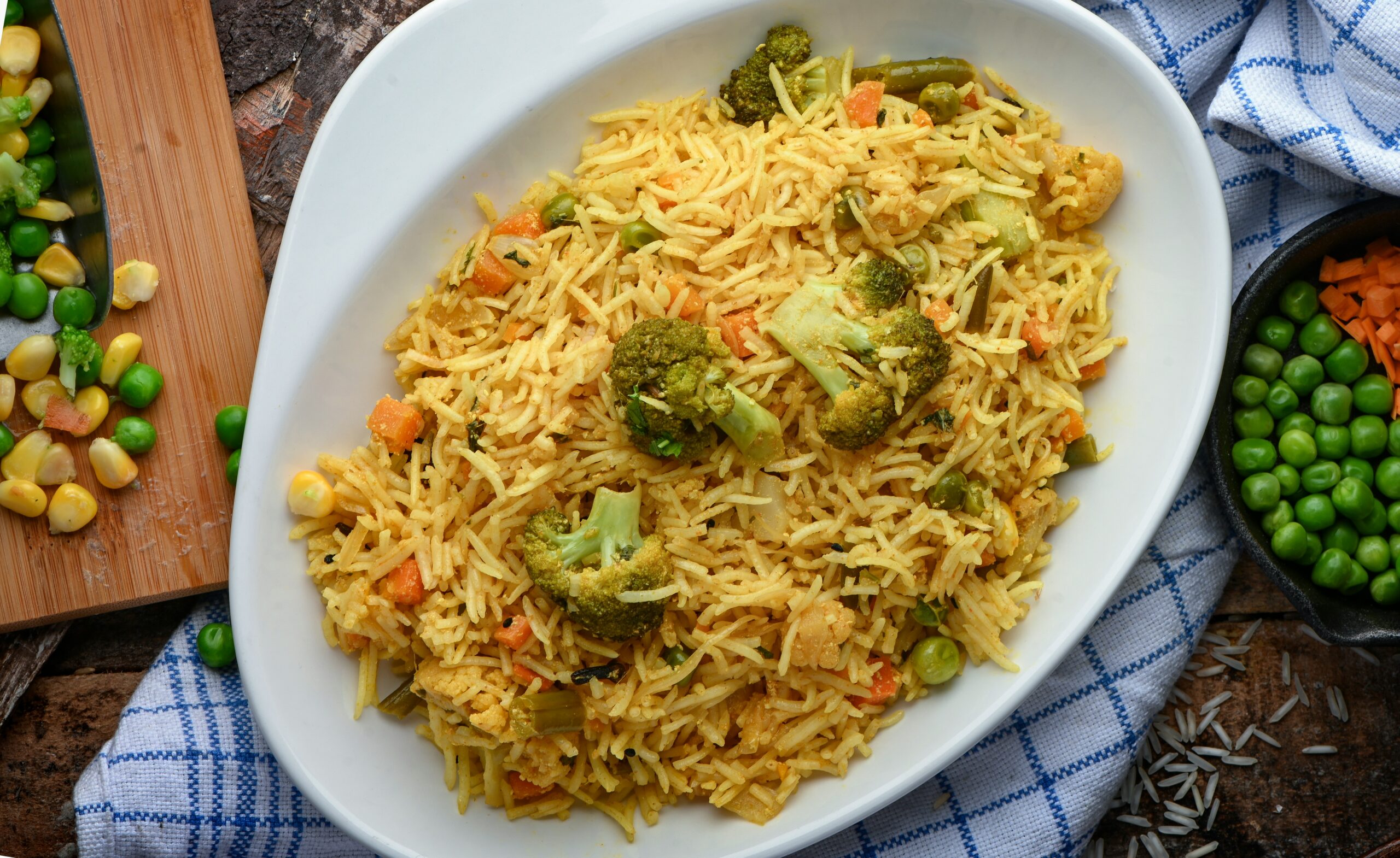 A colorful bowl of vegetable pulao with mixed vegetables, fragrant rice, and garnished with fresh cilantro.